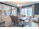 Open-concept dining area showcasing a chandelier, large windows, and seating for six at 633 Foxboro Dr, Avon, IN 46123