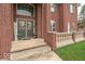 Inviting home entrance with double doors, decorative wreaths, and stylish brick accents at 633 Foxboro Dr, Avon, IN 46123