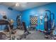 Home gym with blue walls and plenty of equipment at 633 Foxboro Dr, Avon, IN 46123