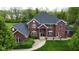 Beautiful red brick home with lush landscaping and a well-manicured lawn in a desirable neighborhood at 633 Foxboro Dr, Avon, IN 46123