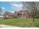 Elegant two-story brick home with manicured lawn, mature trees, and tasteful landscaping at 633 Foxboro Dr, Avon, IN 46123
