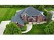 Stately brick home with mature trees and manicured lawn providing curb appeal at 633 Foxboro Dr, Avon, IN 46123