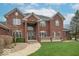 Stately brick home featuring a well-manicured lawn and classic architectural details at 633 Foxboro Dr, Avon, IN 46123
