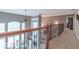 Upstairs hallway with dark wood railing, decorative iron spindles, and multiple large windows at 633 Foxboro Dr, Avon, IN 46123