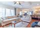 Spacious living room with a fireplace, hardwood floors, and large windows with backyard view at 633 Foxboro Dr, Avon, IN 46123