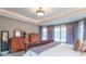 Serene main bedroom with tray ceilings, hardwood furniture, and natural lighting at 633 Foxboro Dr, Avon, IN 46123