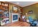 Office space featuring a fireplace, built-in shelving and hardwood floors at 633 Foxboro Dr, Avon, IN 46123