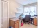 Bright office space with large window, built-in desk, and convenient closet storage at 633 Foxboro Dr, Avon, IN 46123