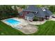 Aerial view of a private backyard oasis featuring a sparkling in-ground pool and patio with lounge chairs at 633 Foxboro Dr, Avon, IN 46123