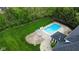 Aerial view of backyard featuring a refreshing in-ground pool, patio area, and lush greenery at 633 Foxboro Dr, Avon, IN 46123