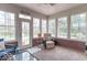 Bright sunroom with ample windows, brick accents, and comfortable seating at 633 Foxboro Dr, Avon, IN 46123