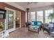 Inviting sunroom featuring brick accents, a ceiling fan, and views of the backyard at 633 Foxboro Dr, Avon, IN 46123