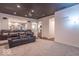 Large entertainment room with tiered seating, home theater, and access to other living areas at 633 Foxboro Dr, Avon, IN 46123