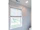 Bathroom window with white trim and cellular shades looking out at a neighborhood at 633 Foxboro Dr, Avon, IN 46123