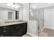 Modern bathroom featuring dual vanities, granite countertop, walk-in shower with glass doors at 634 Dorman St, Indianapolis, IN 46202