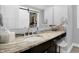 Bathroom with granite countertop, vessel sink, large mirror, and walk-in closet with sliding door at 634 Dorman St, Indianapolis, IN 46202
