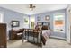 Bedroom with carpet, ceiling fan, two windows, and access to a bathroom at 634 Dorman St, Indianapolis, IN 46202