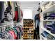 Well-organized walk-in closet with shelving, hanging rods and a shoe rack at 634 Dorman St, Indianapolis, IN 46202