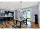 Dining room with modern table and lighting fixture, and a view of the kitchen and backyard at 634 Dorman St, Indianapolis, IN 46202