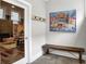 Entryway featuring wood-look tile flooring, a coat rack, a bench, and a view into the living room at 634 Dorman St, Indianapolis, IN 46202