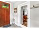 Bright foyer with a stylish wooden door, lantern, and view into a modern office space at 634 Dorman St, Indianapolis, IN 46202