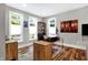 Bright home office with hardwood floors, modern desk, and three windows offering natural light at 634 Dorman St, Indianapolis, IN 46202