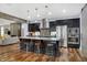 Open concept kitchen with seating at island and stainless appliances, connecting to the living room and dining area at 634 Dorman St, Indianapolis, IN 46202