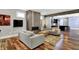 Inviting living room with a modern fireplace, hardwood floors, and an open view to the kitchen at 634 Dorman St, Indianapolis, IN 46202