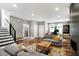 Open concept living space with hardwood floors, fireplace, and stairs leading to the upper level at 634 Dorman St, Indianapolis, IN 46202