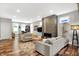 Open concept living room with fireplace, hardwood floors, and a view into the adjacent office space at 634 Dorman St, Indianapolis, IN 46202