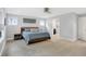 Spacious main bedroom featuring a king bed, ceiling fan, and ensuite bathroom entrance at 634 Dorman St, Indianapolis, IN 46202