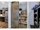 Walk-in pantry with custom shelving, open to a modern kitchen with stainless appliances at 634 Dorman St, Indianapolis, IN 46202
