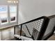 Modern staircase with an open railing and natural light streaming through the window, ascending to the upper level at 634 Dorman St, Indianapolis, IN 46202