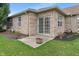 Backyard featuring a brick exterior, sliding glass door, concrete patio, and a grassy area at 6997 Harbour Woods Overlook, Noblesville, IN 46062