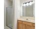 Bathroom featuring a shower with glass doors, light fixture and wooden vanity at 6997 Harbour Woods Overlook, Noblesville, IN 46062