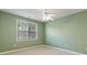 Cozy bedroom with green walls, window providing natural light, and a ceiling fan for added comfort at 6997 Harbour Woods Overlook, Noblesville, IN 46062