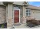 Close up of front door with brick facade and trim and adjacent windows at 6997 Harbour Woods Overlook, Noblesville, IN 46062