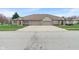Street view of home featuring a brick facade, attached garage, and a well-manicured lawn at 6997 Harbour Woods Overlook, Noblesville, IN 46062
