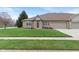Charming brick home with a well-manicured lawn, a cozy entryway, and an attached garage at 6997 Harbour Woods Overlook, Noblesville, IN 46062