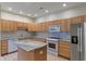 Well-equipped kitchen features stainless steel appliances, ample cabinetry, granite counters, tile backsplash and a large island at 6997 Harbour Woods Overlook, Noblesville, IN 46062
