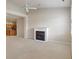 Cozy living room with a fireplace, ceiling fan, and a view into the kitchen at 6997 Harbour Woods Overlook, Noblesville, IN 46062