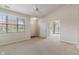 Spacious living area features neutral carpet, ceiling fan, and an abundance of natural light at 6997 Harbour Woods Overlook, Noblesville, IN 46062