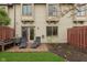 Backyard with chairs on a brick patio, partial fence, and a bit of lawn at 7208 Long Boat Dr, Indianapolis, IN 46250