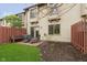 Backyard with chairs on a brick patio, partial fence, and a bit of lawn at 7208 Long Boat Dr, Indianapolis, IN 46250