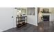 Inviting entryway features stylish bar cart, stairs to upper level and living room at 7208 Long Boat Dr, Indianapolis, IN 46250