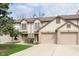 Inviting townhome featuring an attached garage and neutral siding, nestled within a well-maintained community at 7208 Long Boat Dr, Indianapolis, IN 46250