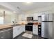 Bright kitchen featuring modern appliances, neutral cabinets, and butcher block countertops at 7208 Long Boat Dr, Indianapolis, IN 46250
