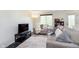 Cozy living room featuring large window for natural light, comfortable seating, and modern decor at 7208 Long Boat Dr, Indianapolis, IN 46250