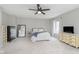 Spacious main bedroom offers ample natural light, a ceiling fan, and modern decor at 7208 Long Boat Dr, Indianapolis, IN 46250