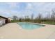 Community pool surrounded by a concrete deck with various trees in the background at 7208 Long Boat Dr, Indianapolis, IN 46250